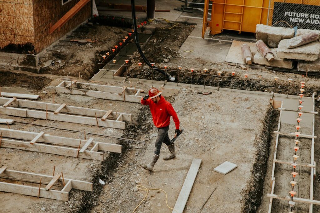 Concrete worker finishing concrete - stock photo by Becca Tapert on Unsplash