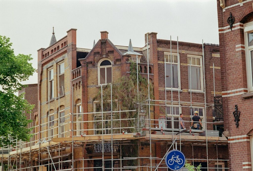 Building facade with scaffolding - stock photo by Artists Eyes on Unsplash
